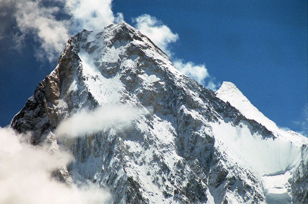 33 Gasherbrum IV And Gasherbrum II Close Up From Baltoro Glacier Between Goro II and Concordia Gasherbrum IV would probably be a more popular climbing mountain if it was 75m taller. At 7925m, it is the 17th highest mountain in the world. Gasherbrum II (G2, 8035m) pokes out to the right of Gasherbrum IV. On June 22, 1986 Greg Child, Tim Mcartney-Snape, and Tom Hargis climbed to the North Summit and traversed 450m horizontally to the true Gasherbrum IV Summit, completing the first ascent of the Gasherbrum IV Northwest Ridge. We functioned as a single being. Now on the summit, that being, drunk with euphoria, felt suddenly as if it had been merged with sky and mountain as well to become a single, elemental entity. - Thin Air: Encounters In The Himalaya by Greg Child.